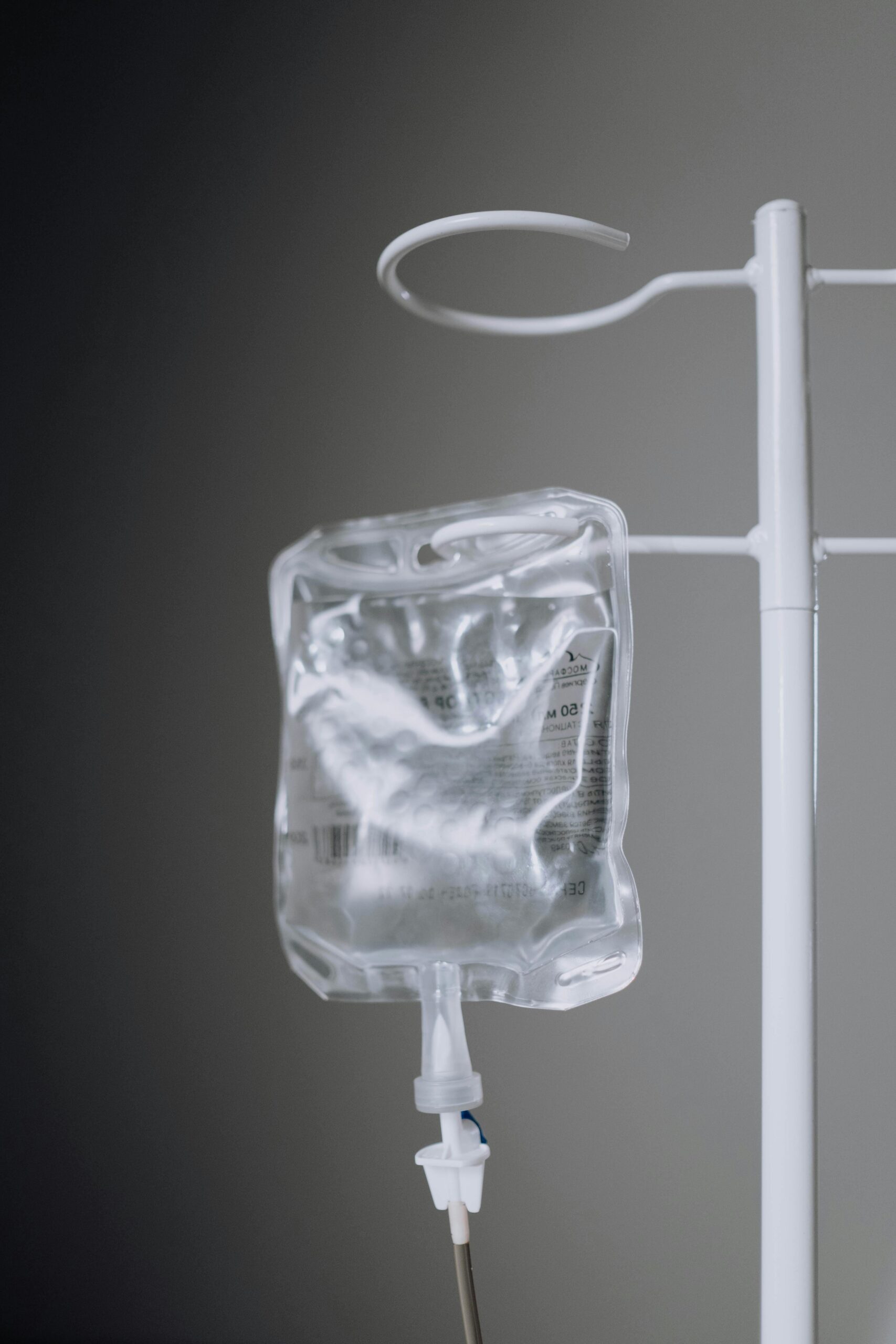 A close-up view of an IV fluid bag hanging on a pole, ideal for healthcare concepts.